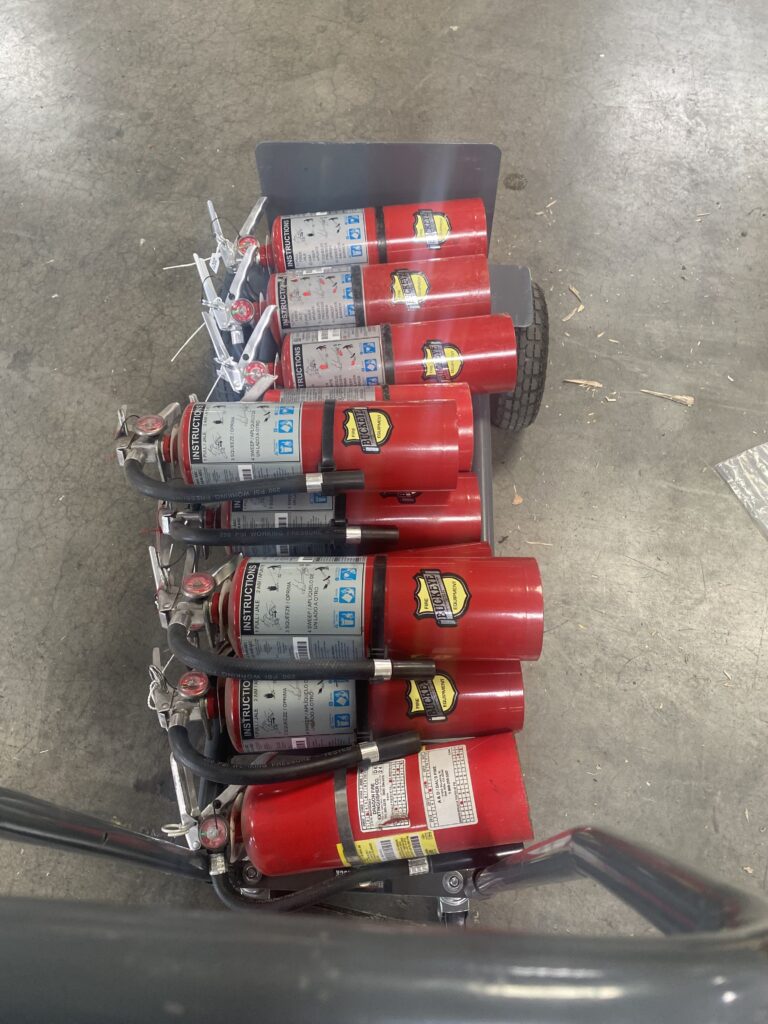 Portable Fire Suppression Cylinders Secured in Metal Rack